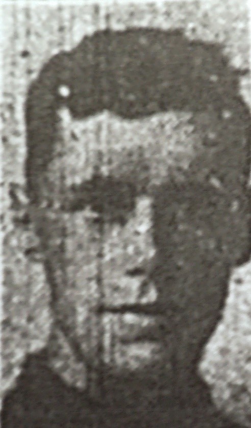 copy of a black and white photograph possibly taken from a newspaper of his head and shoulders