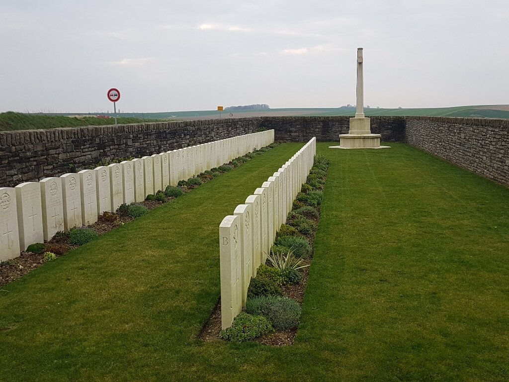 Montbrehain British Cemetery with rows of graves enclosed within a stone wall