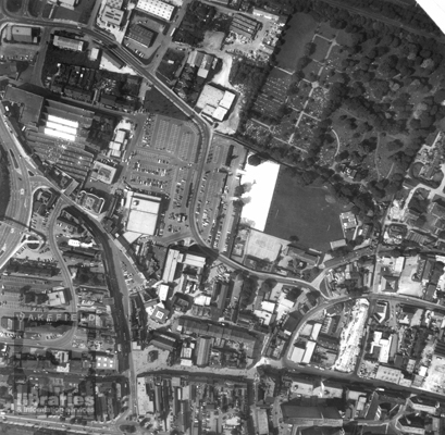 A black and white aerial photograph of Pontefract Town Centre, with the Market Place, Horsefair, Beastfair, Cornmarket, Stuart Road, Finkle Street, Gillygate, Ropergate and Southgate visible.  Dunhills Liquorice Factory is centre left.  Internal Reference: PO A116