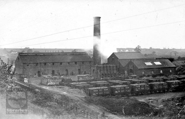A slide of a black and white photograph of the brickworks that became part of Walton Colliery complex, often referred to as Sharlston West Colliery, which used the shale to make brick.  The National Coal Board closed the colliery in December 1979.  The viaduct can be seen in the background.  Internal Reference: WR Box W number 35