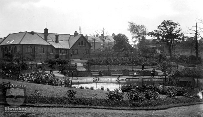 Hawe Hill Park in Normanton A black and white postcard showing Hawe Hill Park, off Castleford Road, Normanton. The picture shows the back of Normanton Library and terrace houses can be seen on Castleford Road. The lake is visible in the foreground. The park was opened between 1904 and 1905. There were ornamental lakes, a bowling green, bandstand and a children's playground. This was the centre of recreational activities in Normanton. Internal Reference: Private Collection