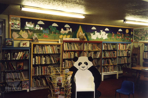 The Children's Department at Castleford Library 1998 A colour photograph of the Children's Library at Castleford. A cut-out Panda provides a seat. Across the walls a colourful display depicting spring reflects the brightly coloured bookcases. Internal Reference: CA YILLUS 498