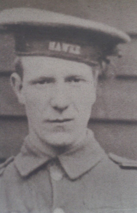 head and shoulders of joseph in his naval uniform, his cap has the word Hawke on it