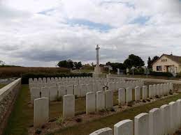 white gravestones in a row within a cemetery