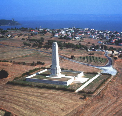 Photo of Helles Memorial. A large white tower bordered by a white wall in a square shape.