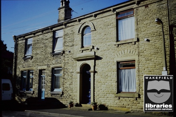 A colour slide of terrace houses on the right hand side of the top of Brook Street, Ossett. Brook Street was developed by Joseph Brook. Internal Ref: Ossett Library

